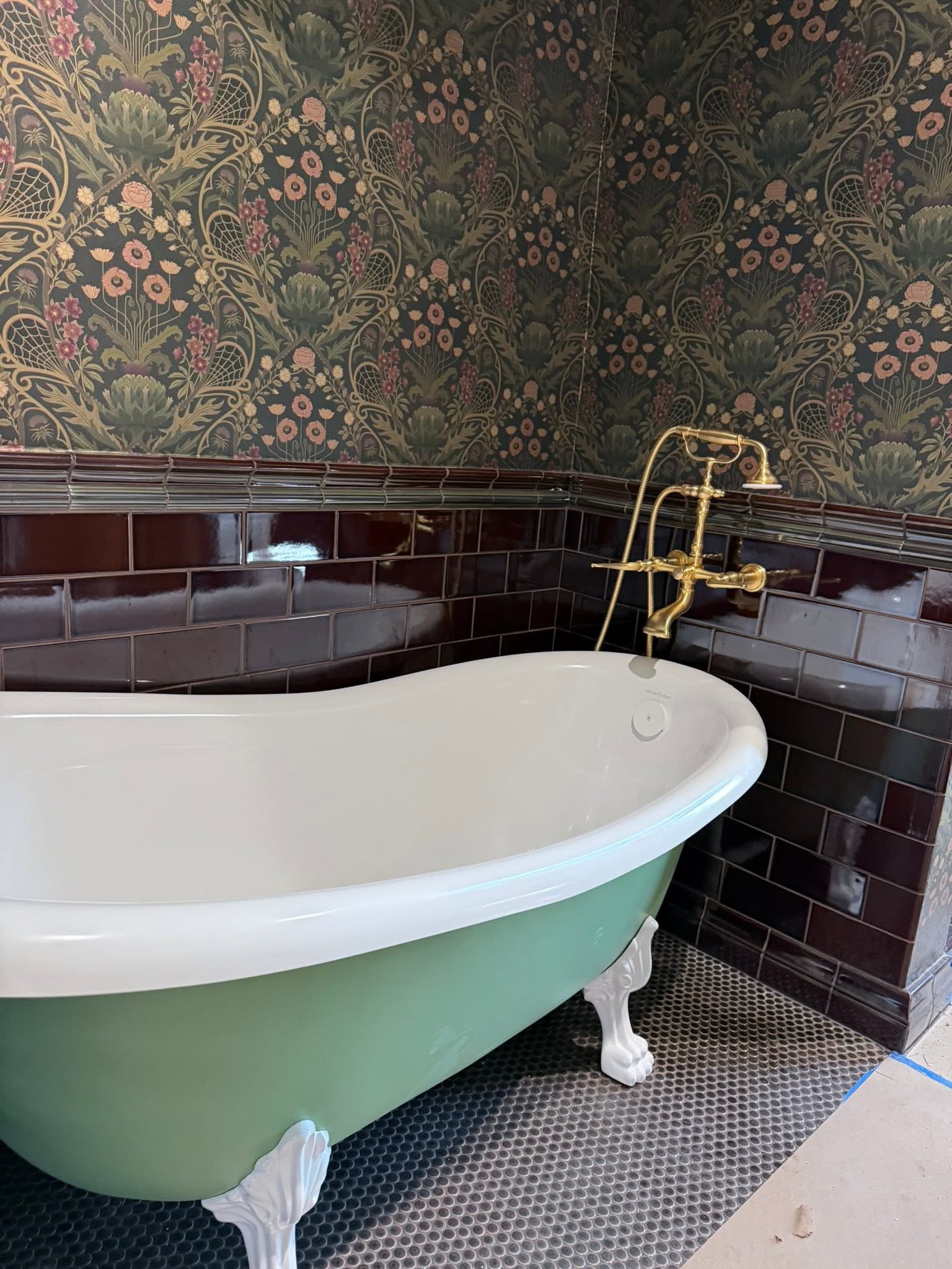 Clawfoot bathtub with brass wall-mounted fixture