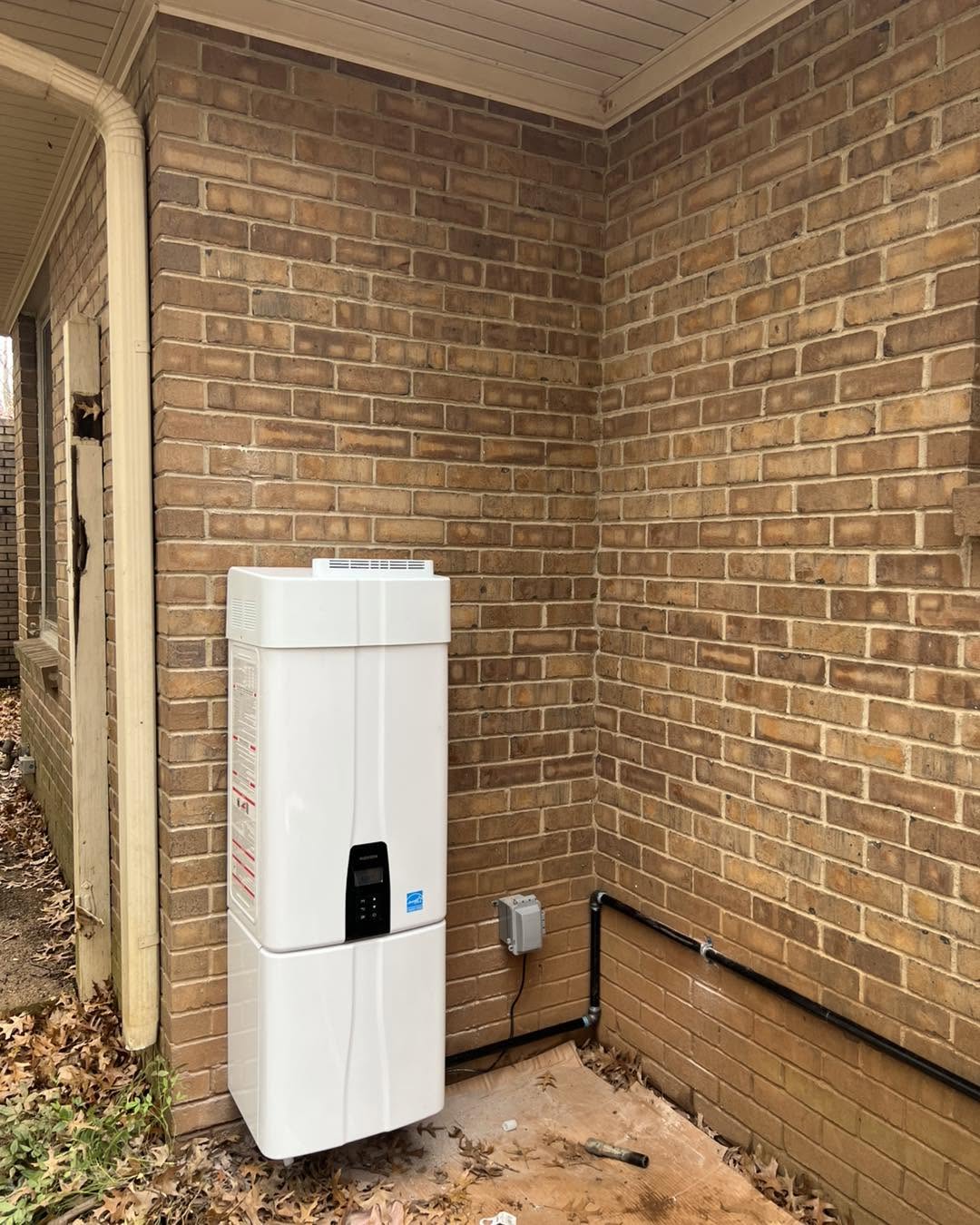 Exterior tankless unit mounted on brick wall