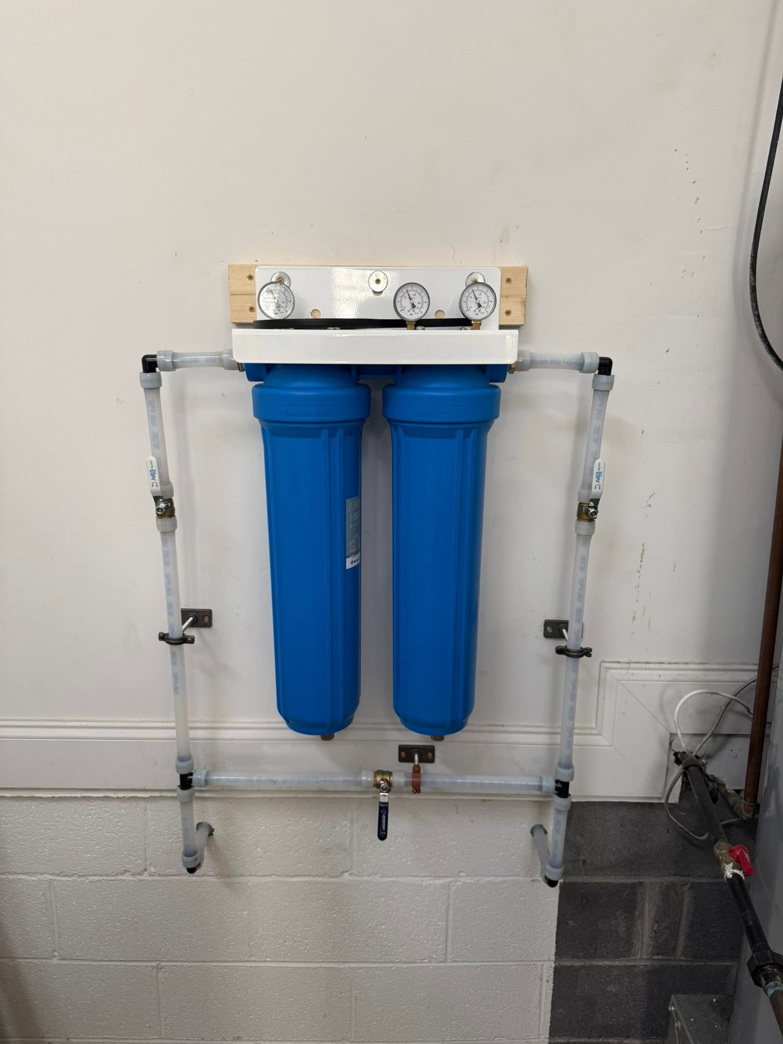 Close-up of dual blue filter manifold and pressure gauges