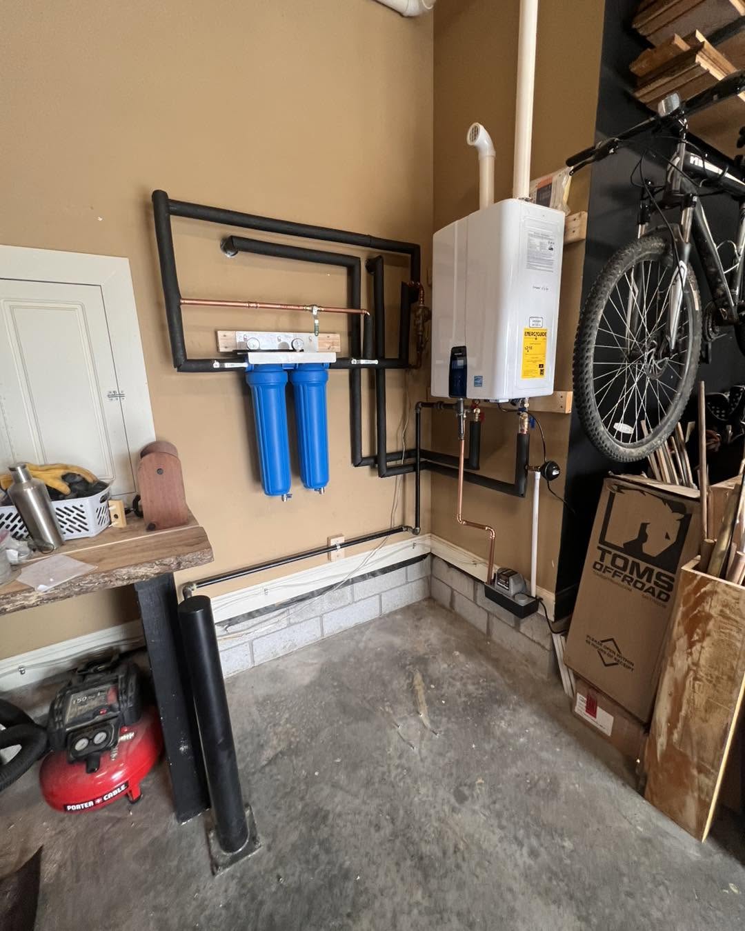 Garage mechanical wall with tankless water heater and water filters
