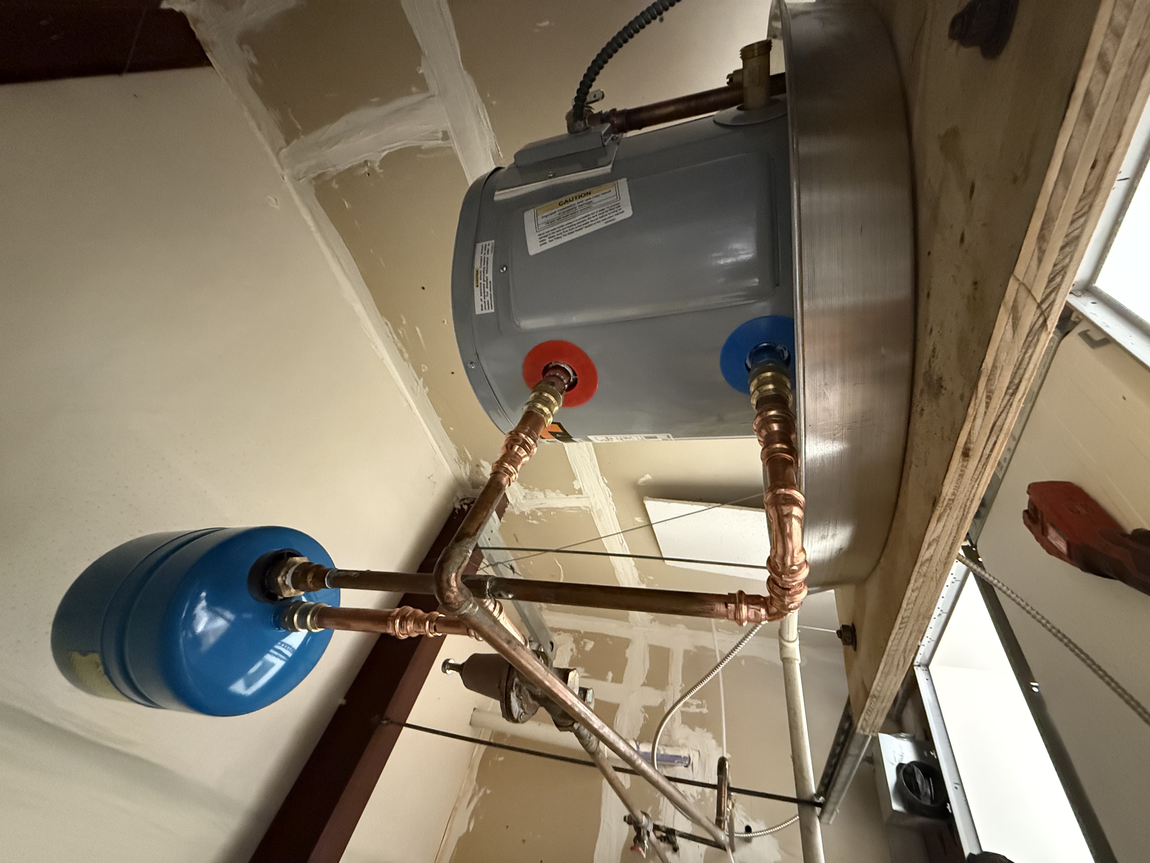 Water heater installation with copper piping and expansion tank