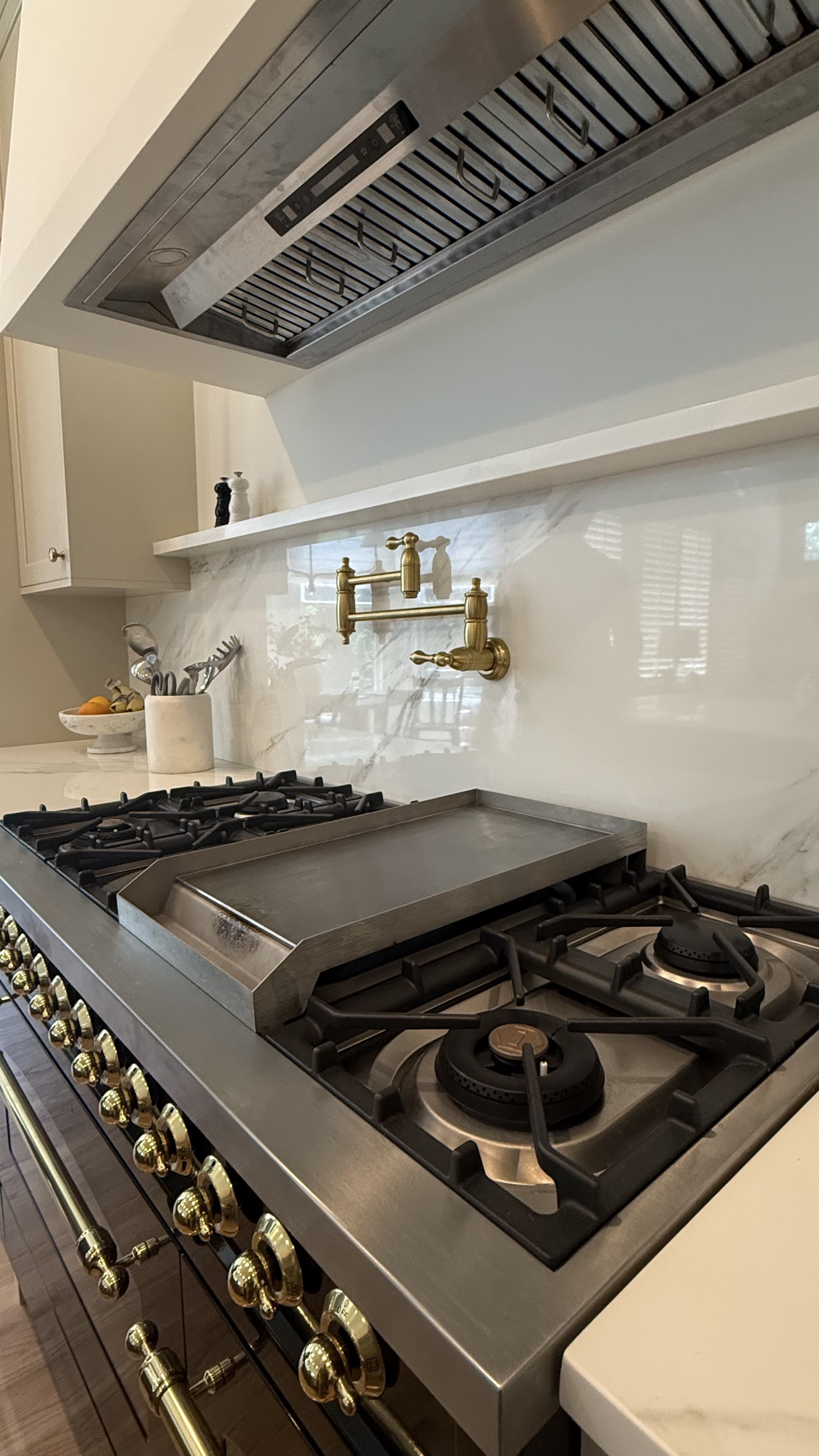 Pot filler installed above commercial-style kitchen range