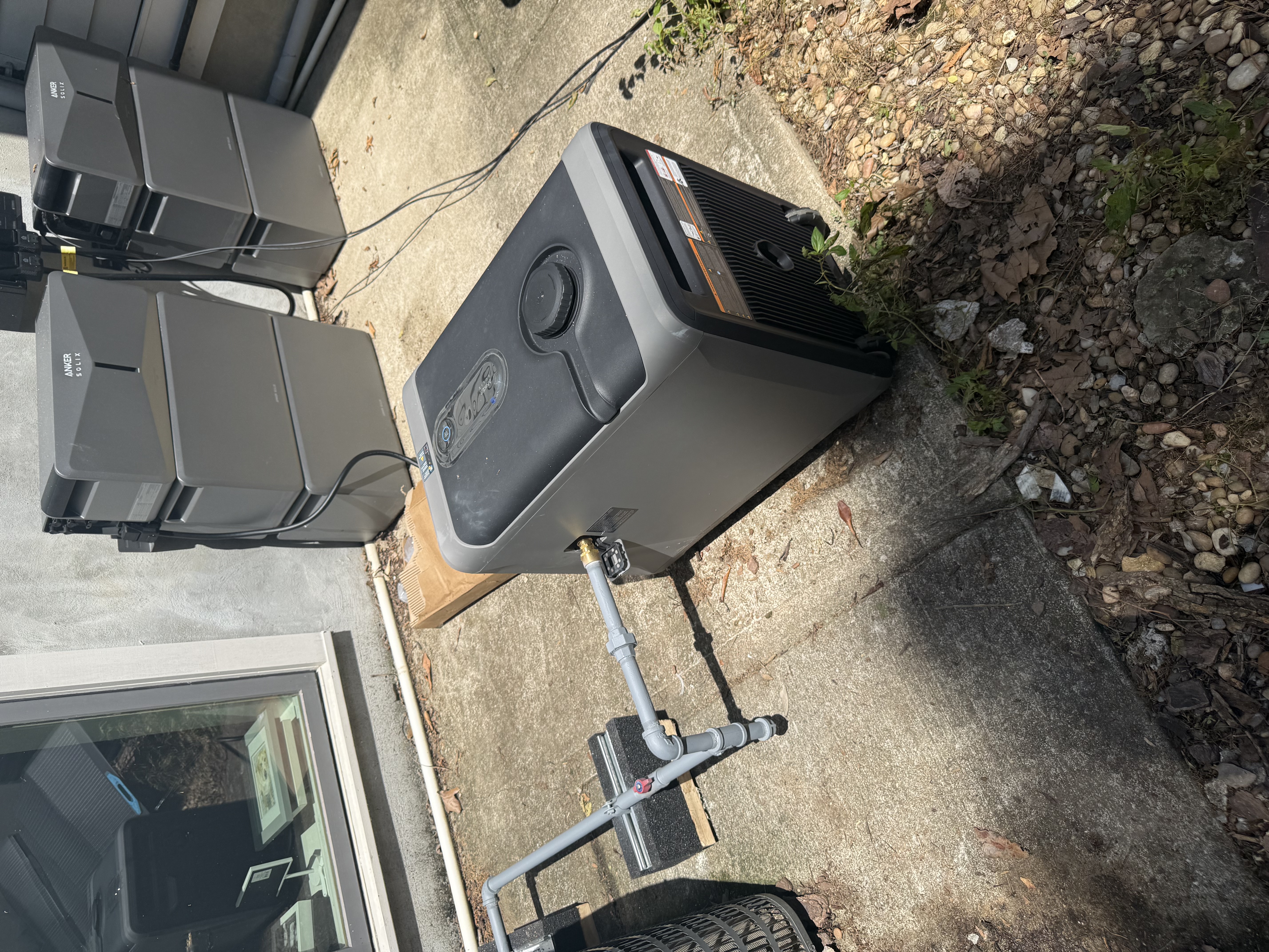 Outdoor equipment and plumbing connection on concrete pad