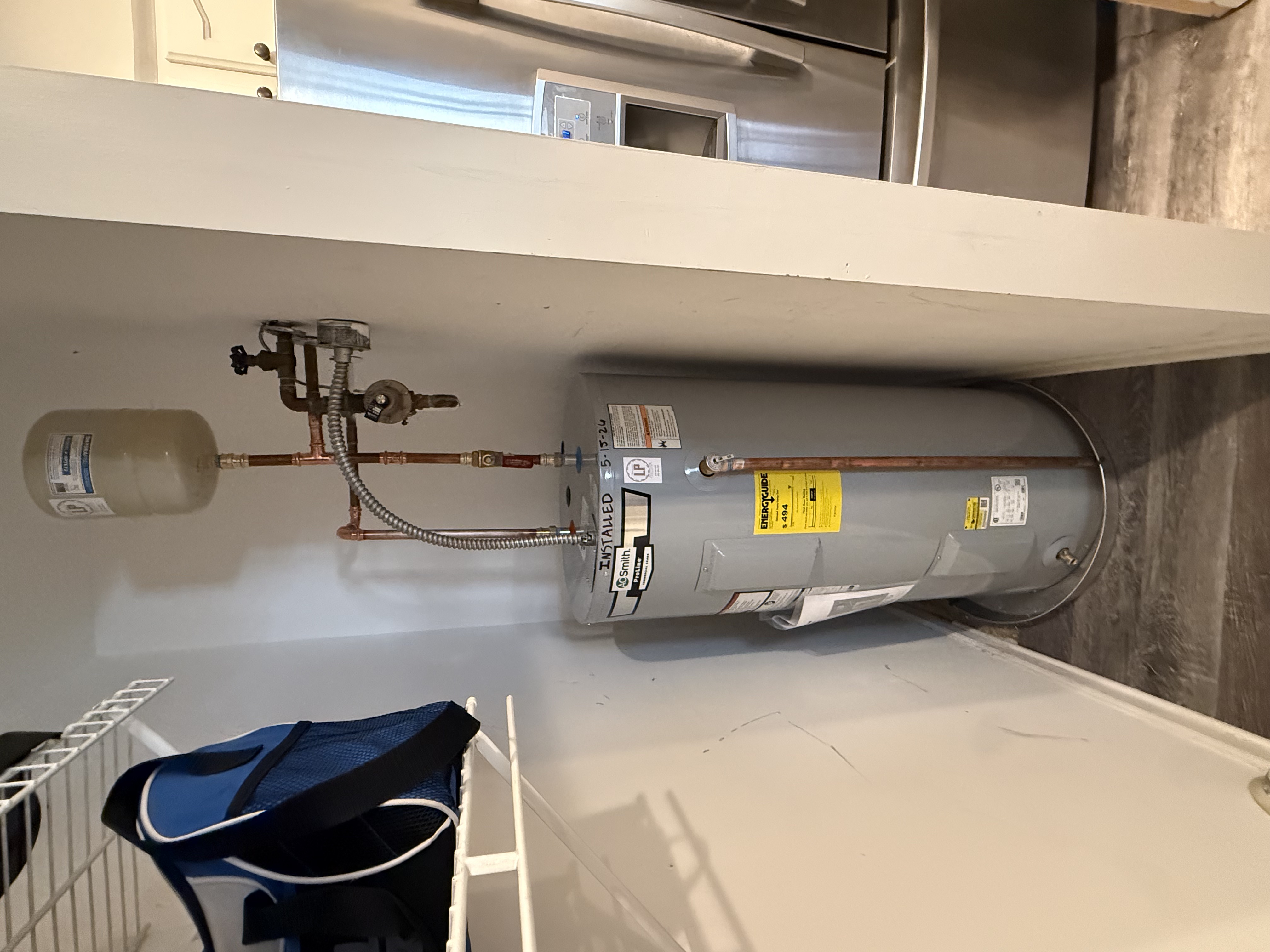 Residential water heater installation in utility closet