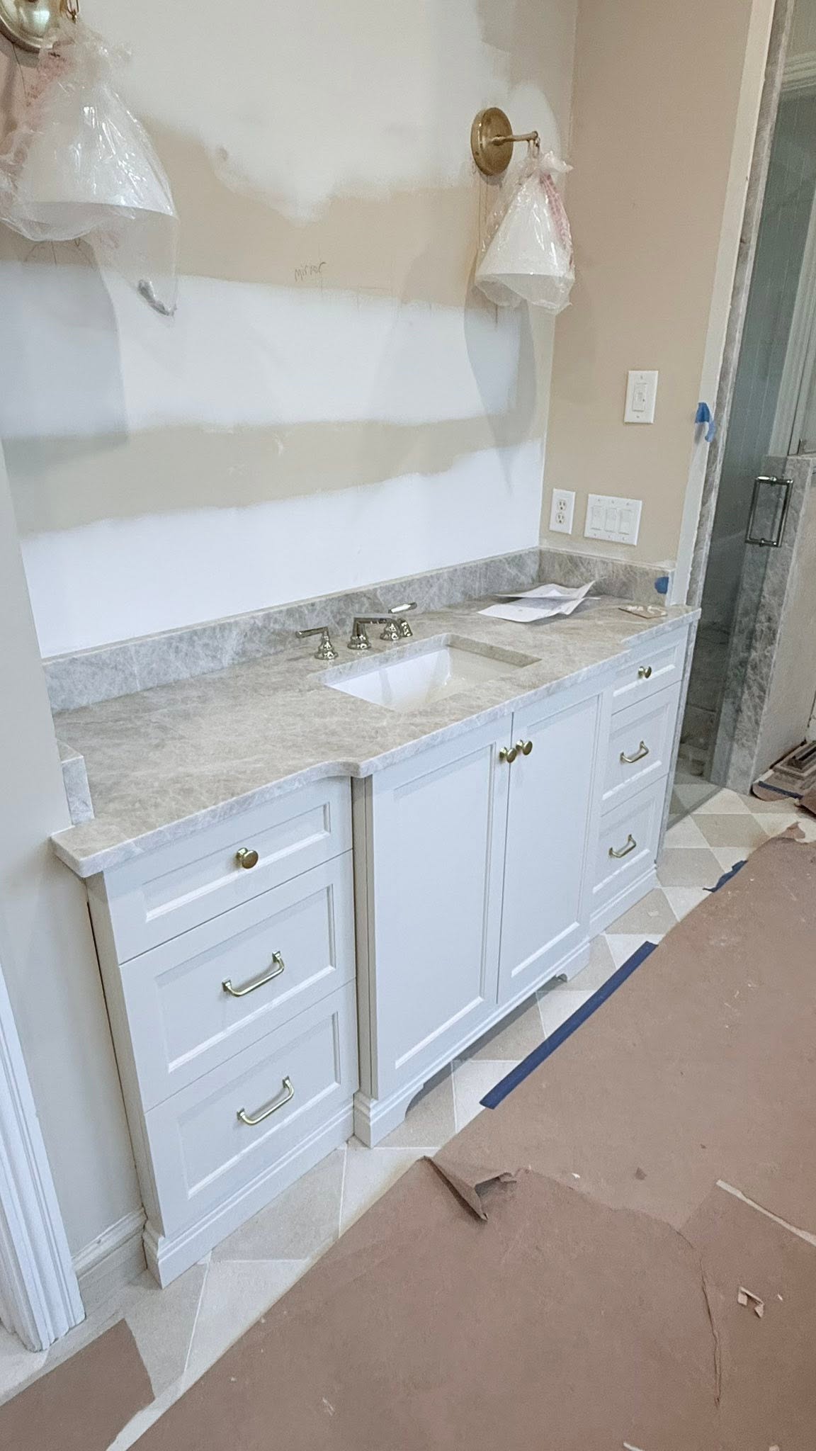 Bathroom vanity plumbing and countertop installation in progress